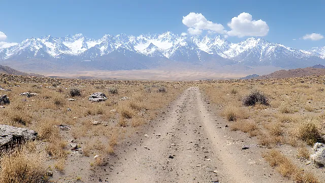 Sky, Mountain, Ecoregion, Cloud, Natural landscape, Mountainous landforms, Landscape, Snow, Road, Aeolian landform, Grassland, Mountain range, Valley, Geology, Plateau, Sand, Hill, Horizon, Dirt road, Rock