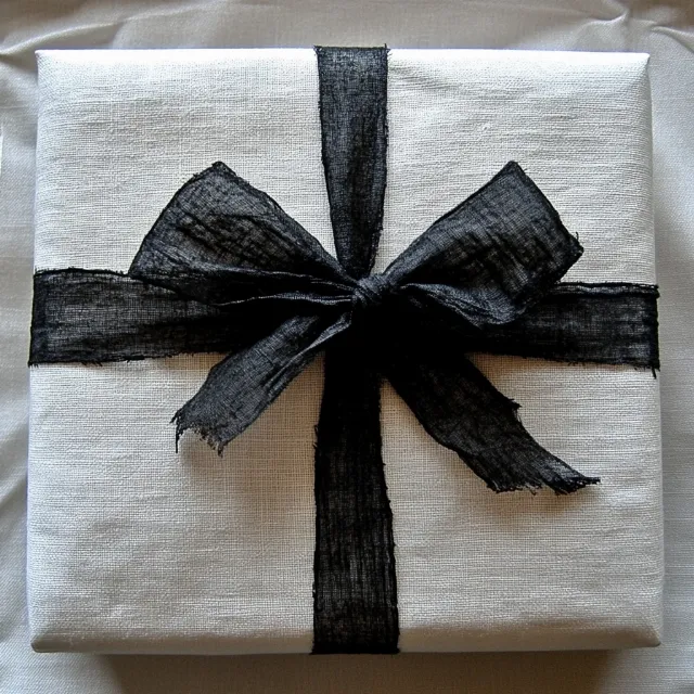 Black, Gift wrapping, Gift, Paper, Ribbon, Linens, Grey, Paper Product, Silver, Knot, Design, Party Supply, Party favor, Hair tie