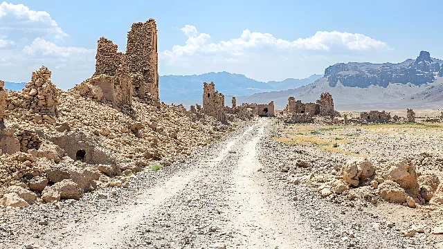 Sky, Cloud, Ecoregion, Mountain, Bedrock, Landscape, Mountainous landforms, Road, Geological phenomenon, Formation, Building, Road surface, Dirt road, Valley, Aeolian landform, Soil, Rock, Plateau, Hill, Ancient history