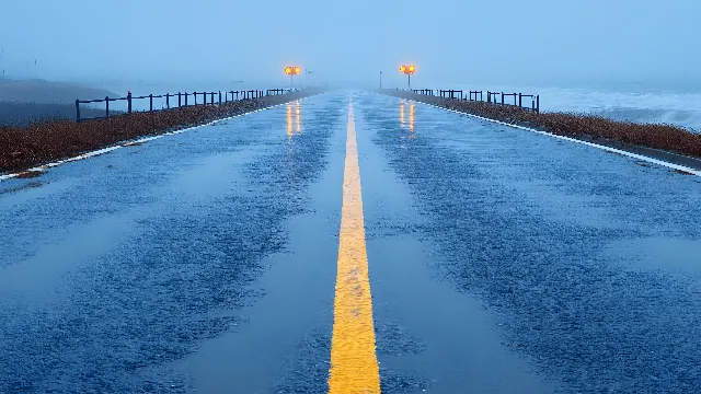 Water, Sky, Infrastructure, Road surface, Body of water, Asphalt, Thoroughfare, Line, Morning, Parallel, Horizon, Symmetry, Bridge, Road, Electric blue, Public utility, Freezing, Walkway, Street light, Landscape