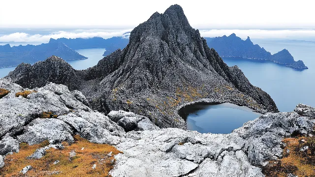 Mountain, Mountainous landforms, Water, Body of water, Natural landscape, Rock, Highland, Wilderness, Hill, Terrain, Mountain range, Coastal and oceanic landforms, Geological formation, Ridge, Promontory, Coast, Headland, Lake, Geology, Tarn