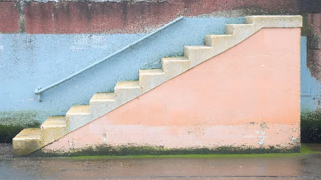 Stairs, Orange, Composite material, Handrail, Paint, Concrete, Building material, Still life photography, Shadow, Plaster