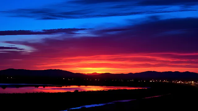 Cloud, Sky, Atmosphere, Water, Afterglow, Natural landscape, Dusk, Sunset, Sunlight, Sunrise, Red sky at morning, Horizon, Landscape, Tree, Morning, Cumulus, Waterway, Calm, Magenta, Hill