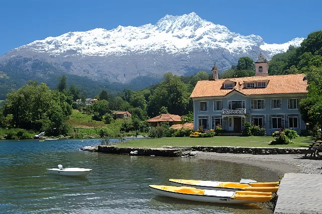 Mountainous landforms, Mountain, Mountain range, Natural landscape, Highland, Hill, House, Hill station, Bank, Lake, Glacial landform, Alps, Cottage, Valley, Summit, Ridge, Boat, Loch, Village, Channel